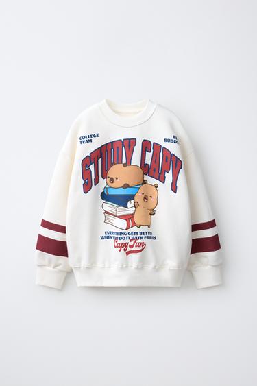 Ecru Zara-sweater met capybaraprint en gestreepte mouwen